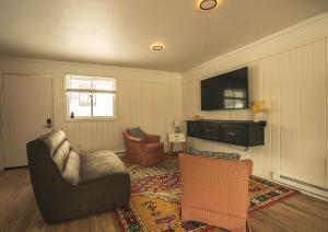 a living room with a couch and a chair at The Boha Hotel in Lake Placid