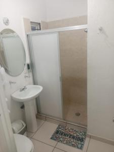 a small bathroom with a sink and a shower at Casa Lisboa in Puerto Vallarta +9 photos