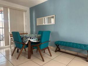 a dining room with a table and two chairs at Casa Lisboa in Puerto Vallarta