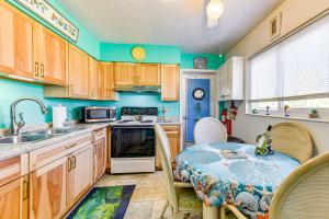 a kitchen with wooden cabinets and a table and chairs at Pet-Friendly Bradenton Home 1.5 Mi to Cortez Beach in Bradenton