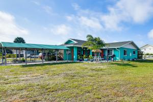a blue house with a yard in front of it at Pet-Friendly Bradenton Home 1.5 Mi to Cortez Beach in Bradenton