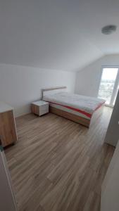 a bedroom with a bed and a wooden floor at Villa Nova Ohrid in Ohrid