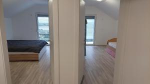 a bedroom with a bed and two windows in a room at Villa Nova Ohrid in Ohrid