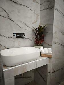 a bathroom with a white sink on a counter at Lūma Retreat in Kastoria