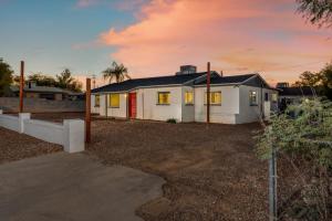 a white house with a red door in a yard at Santa Rita Primary (Mike Morgan) in Tucson