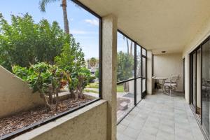 an internal view of a house with windows and a patio at IMG Condo Near Golf Course in Bradenton