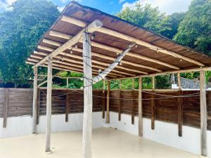 a wooden pergola on top of a building at Villa Las Malaguenas in Las Terrenas