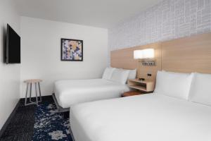 a hotel room with two beds and a tv at Aiden by Best Western Berkeley in Berkeley