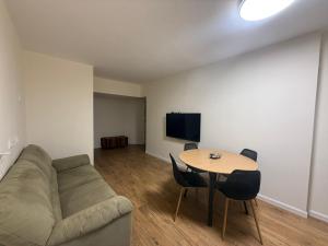 a living room with a couch and a table with chairs at Las Palmas in Eilat