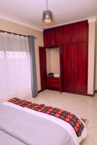 Ένα ή περισσότερα κρεβάτια σε δωμάτιο στο Zaza Homes Kabalagala