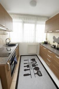 a kitchen with a kitchen rug on the floor at Mid Velvet Apartment, Free Parking, Self Check-in in Oradea