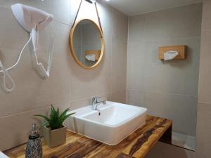 a bathroom with a sink and a mirror at Ferienwohnung am Hotel "Mein Bergblick" in Goslar