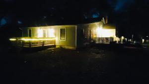 een klein huis 's nachts met lichten aan bij Quiet Private Room at McAfee Shared Bathroom Room 3 in Decatur