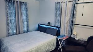 een slaapkamer met een bed en een raam met gordijnen bij Quiet Private Room at McAfee Shared Bathroom Room 3 in Decatur