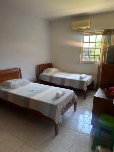 En eller flere senge i et værelse på Casa do Sonho