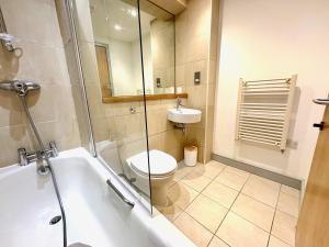 a bathroom with a toilet and a sink and a shower at York City Centre 2 bed Flat with Disable Access 2 bath - Balcony and City View in York +10 photos