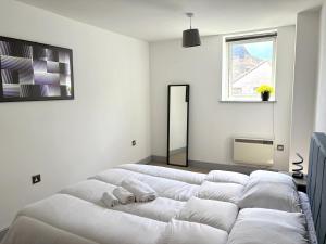 a white room with a large white bed in it at York City Centre 2 bed Flat with Disable Access 2 bath - Balcony and City View in York