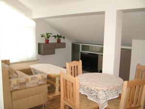 a living room with a table and chairs and a television at Kisiovi Apartment in Devin