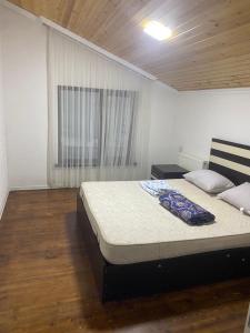 a bedroom with a bed and a window at Дом в Гусаре in Qusar