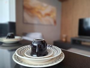 a black and white cup on a plate on a table at LK Barro Preto 16 in Belo Horizonte +32 photos