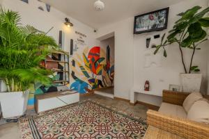 a living room with potted plants and a couch at Casa Moraira in Cartagena de Indias