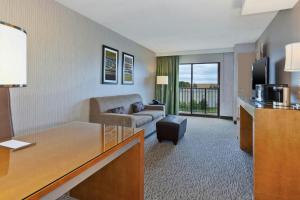 a living room with a couch and a television at Hotel Auburn Hills in Auburn Hills