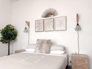 ein Schlafzimmer mit einem Bett und drei Bildern an der Wand in der Unterkunft Beautiful 3BD 2B - Weatherford - Same Day Bookings in Weatherford