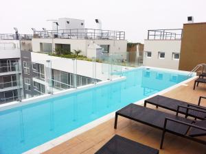 a swimming pool on the roof of a building at Wasi Apartment Pardo in Lima