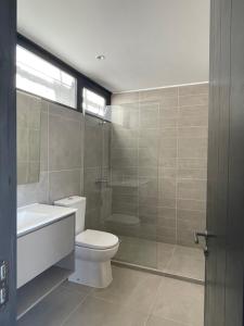 een badkamer met een toilet, een wastafel en een douche bij Rompe Olas in Maitencillo