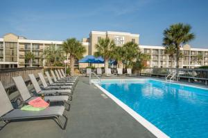 a hotel pool with lounge chairs and a resort at Hotel Tybee in Tybee Island