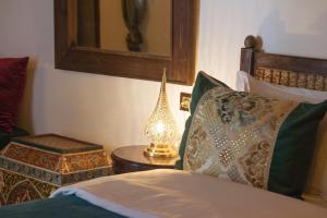 a bedroom with a bed and a lamp on a table at Riad Ruh Fes in Fez