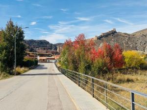 a road with a fence on the side of a mountain at El Sueño de Albarracin III in Albarracín
