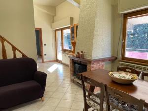 a living room with a table and a fireplace at Montaria Suite in Pescocostanzo