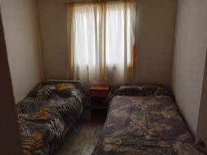 Ένα ή περισσότερα κρεβάτια σε δωμάτιο στο Hospedaje Flia SESA