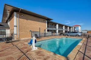 a swimming pool in front of a building at SureStay Hotel by Best Western Terrell in Terrell