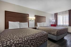 a hotel room with two beds and a window at SureStay Hotel by Best Western Terrell in Terrell +28 photos