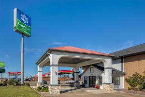 a gas station with a sign in front of it at SureStay Hotel by Best Western Terrell in Terrell
