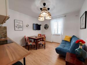 a living room with a blue couch and a table at House House Jadranovo in Jadranovo