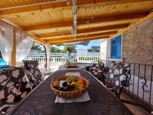 a basket of fruit on a table on a balcony at House House Jadranovo in Jadranovo