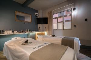 a surgery room with two beds and a window at Pandora House in Mexico City