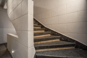 a staircase in a building with a stone wall at Pandora House in Mexico City