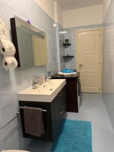 a bathroom with a sink and a mirror at La casa di Alice in Orbassano +7 photos