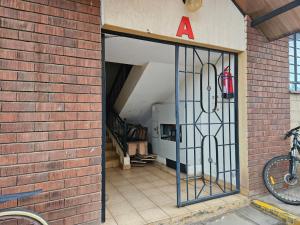 an entrance to a brick building with a door at The Monarch Suites- Peaceful Luxe 2BR with view in Nakuru