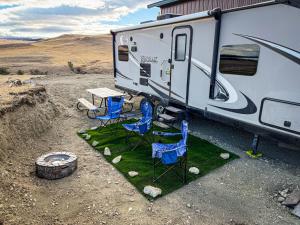 een kampeerplaats met een tafel en stoelen en een caravan bij Camper Adventure in Livingston +5 foto's