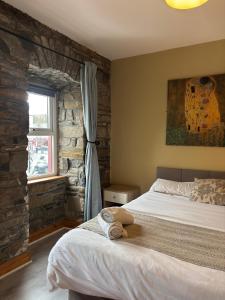 En eller flere senge i et værelse på The Nest on The Octagon