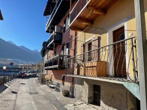 a building with balconies on the side of a street at Gran Paradiso Alpine Lodge in Aosta