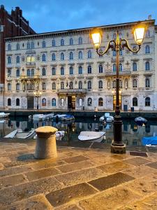a street light in front of a large building at Trieste Sea Life in Trieste +18 photos