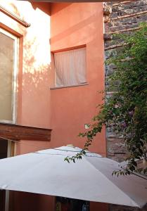 un ombrello bianco seduto di fronte a un edificio di Loft Mansardato a Catania