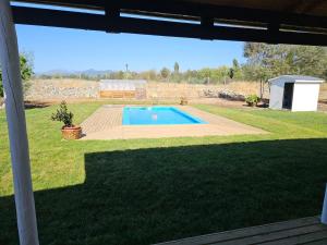 a view of a yard with a swimming pool at Ribera del Ancoa in Llepu +30 photos