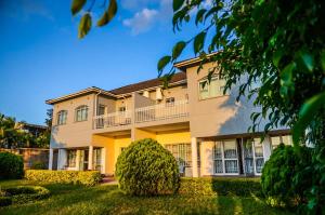 a large apartment building with a yard at Kabula Lodge in Blantyre